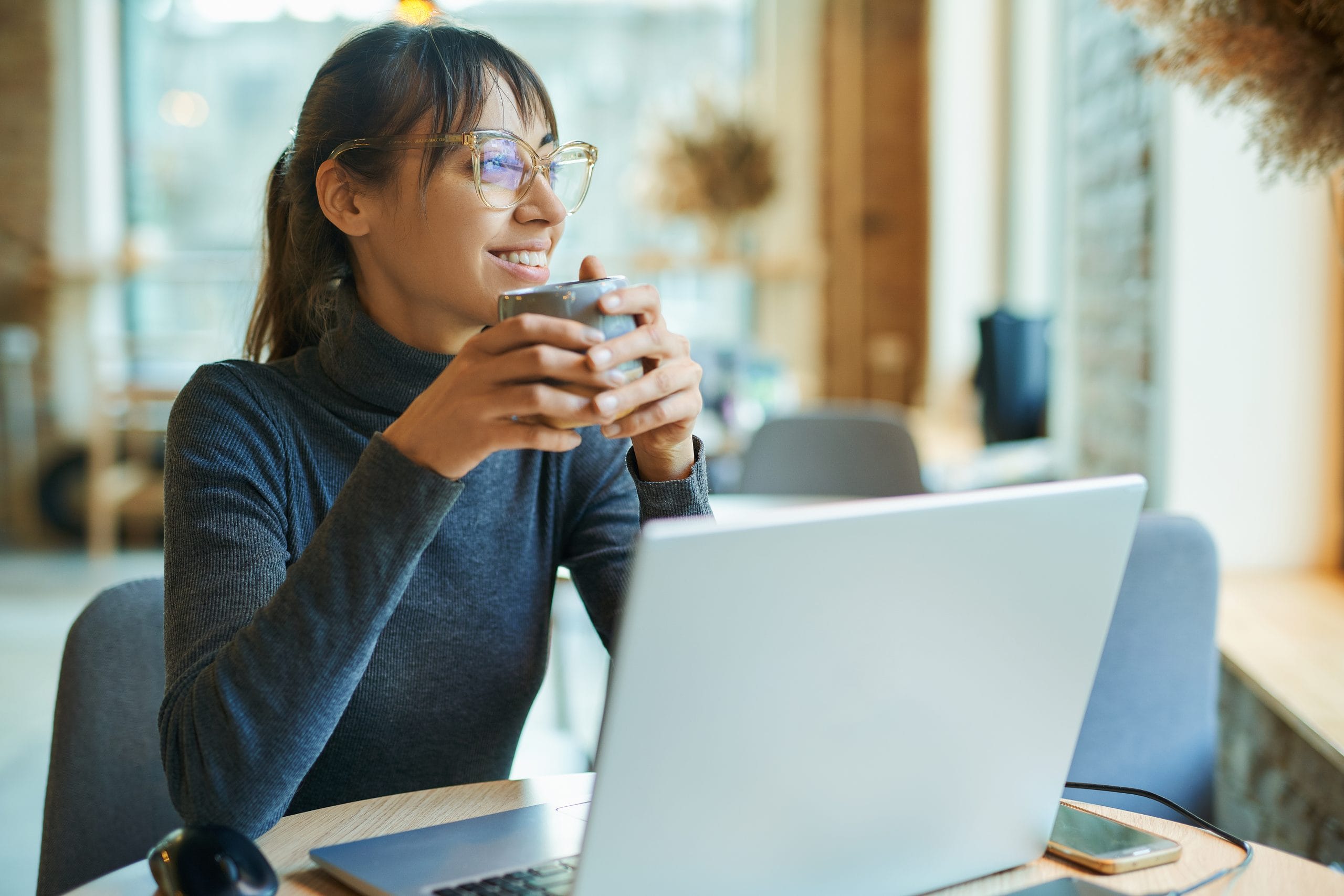 Woman working from her home or a cafe